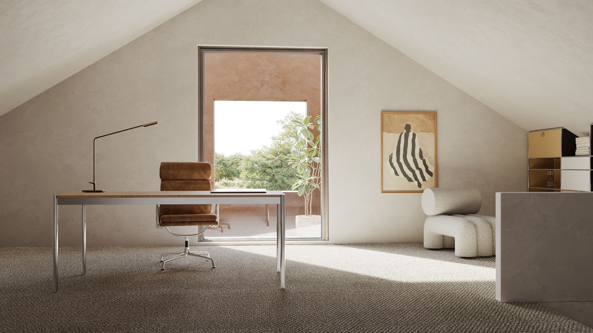 Attic studio of Casa Horizonte: a desk and leather chair under a pitched ceiling, with a large window at the gable