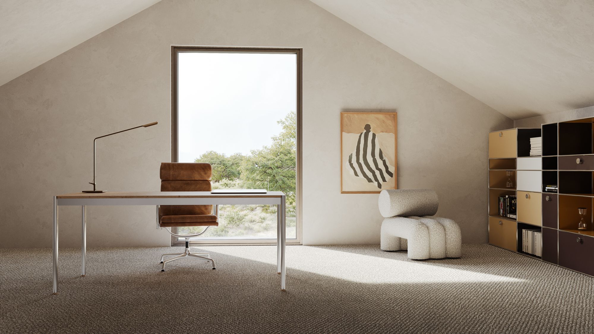 Attic studio of Casa Miradouro: a desk and leather chair under the pitched ceiling, a tall window at the gable