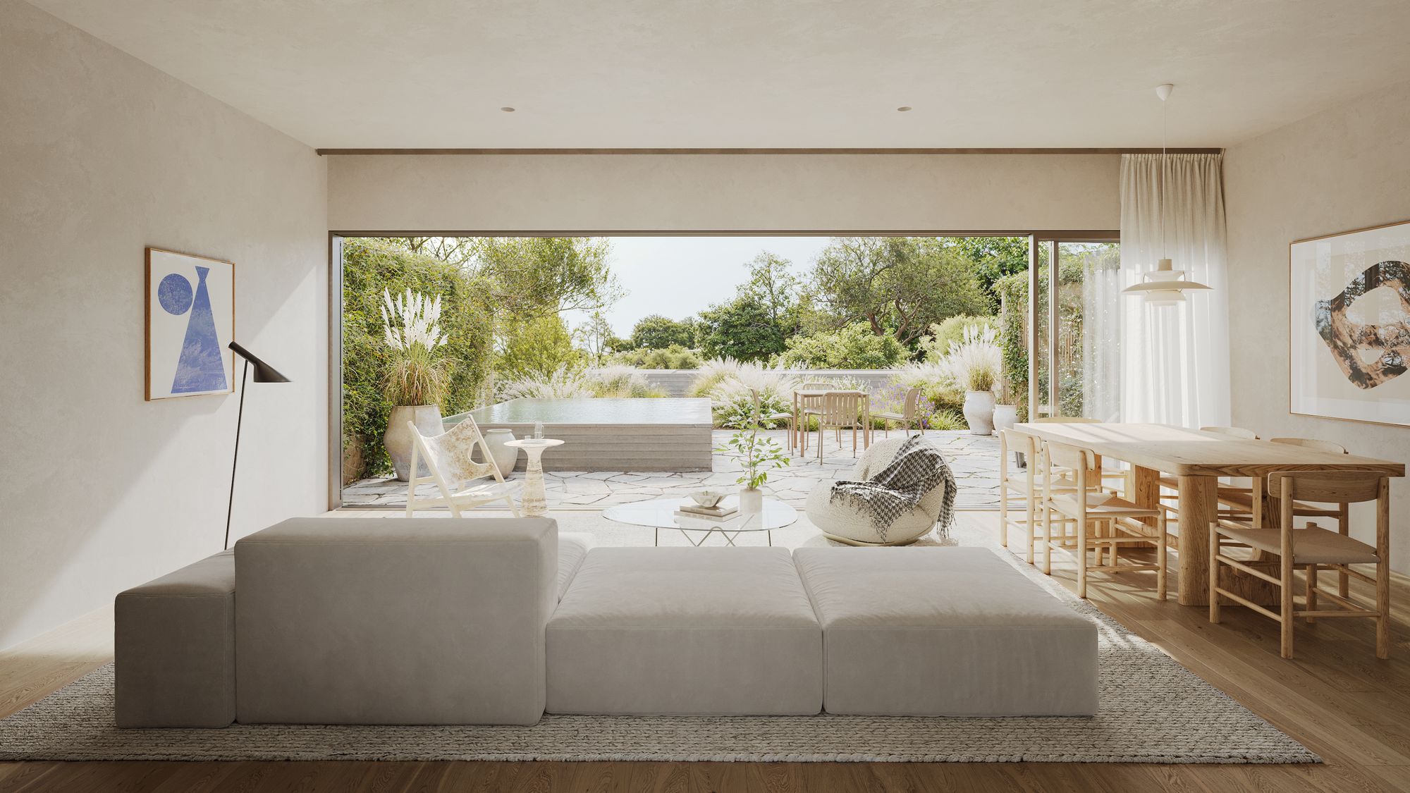 Living and dining room of Casa Miradouro with a long oak table, a modular sofa and sliding glass open onto a terrace with a plunge pool
